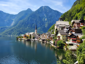 houses near body of water and mountain during daytime