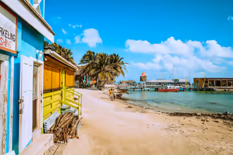 brown wooden beach chairs near body of water during daytime
